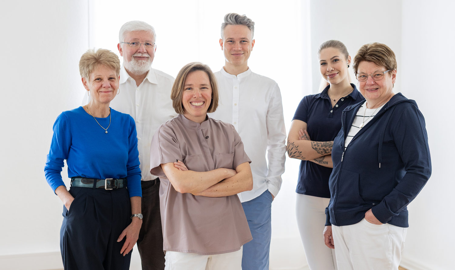 Das Team der Praxis Dr. Beckmann steht zusammen und lächelt in die Kamera